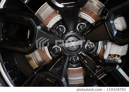 Detailed shot of a sleek black and silver alloy wheel on a motor vehicle Detailed shot of a sleek black and silver alloy wheel on a motor vehicle 119329785