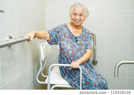 Asian elderly old woman patient use toilet support rail in bathroom, handrail safety grab bar, security in nursing hospital. Asian elderly old woman patient use toilet support rail in bathroom, handrail safety grab bar, security in nursing hospital. 119330236