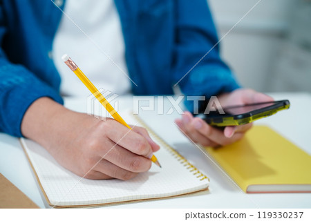 Asian teenage student write homework with laptop computer, learning university education. Asian teenage student write homework with laptop computer, learning university education. 119330237