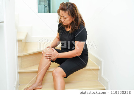 Asian lady woman injury from falling down on slippery surfaces stairs at home. Asian lady woman injury from falling down on slippery surfaces stairs at home. 119330238