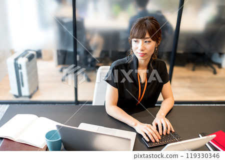 A businessperson trying to relieve eye strain by looking at a distant view during a break from computer work A businessperson trying to relieve eye strain by looking at a distant view during a break from computer work 119330346