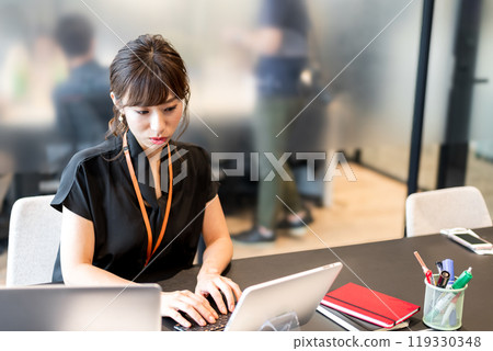 A business person multitasking using a computer and tablet A business person multitasking using a computer and tablet 119330348