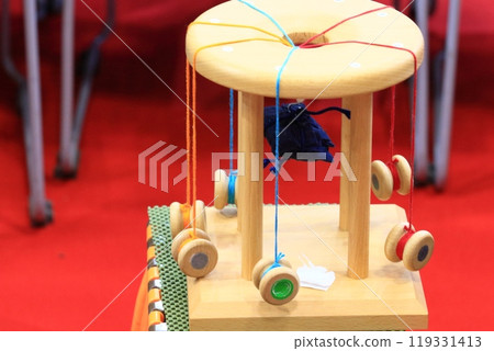 A braiding stand for weaving braids - the traditional craft of braiding 119331413