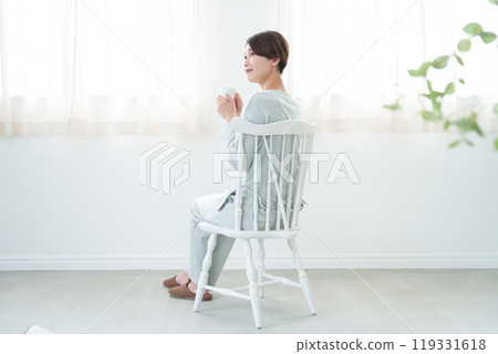 A woman wakes up in the morning and drinks a mug A woman wakes up in the morning and drinks a mug 119331618