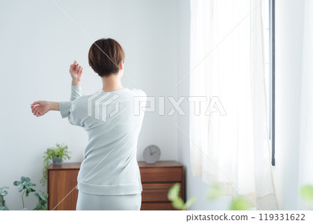 Woman stretching in pajamas in the morning 119331622