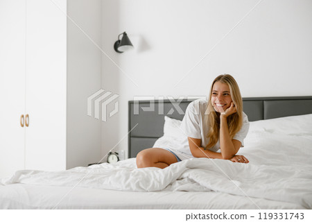 A Relaxed Morning Experience in a Bright and Welcoming Bedroom Filled with Warmth and Light 119331743