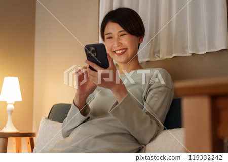 A woman watching a night smartphone A woman watching a night smartphone 119332242