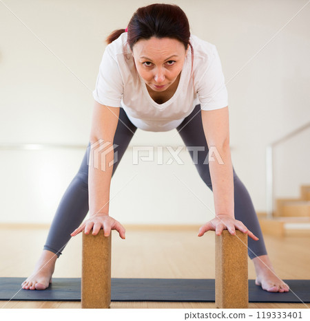 Pregnant woman is engaged in yoga. Standing Half Forward Bend or Ardha Uttanasana 119333401