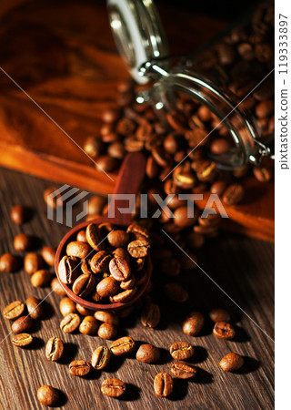 Coffee beans spilling from a coffee canister Coffee beans spilling from a coffee canister 119333897