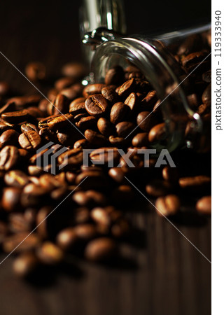 Coffee beans spilling from a coffee canister Coffee beans spilling from a coffee canister 119333940