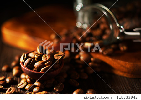 Coffee beans spilling from a coffee canister 119333942