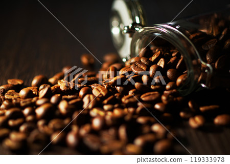 Coffee beans spilling from a coffee canister Coffee beans spilling from a coffee canister 119333978
