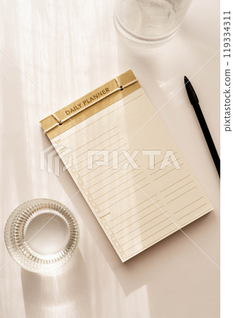 Top view minimalist daily planner with a simple design, featuring checkboxes and lines for tasks Top view minimalist daily planner with a simple design, featuring checkboxes and lines for tasks 119334311