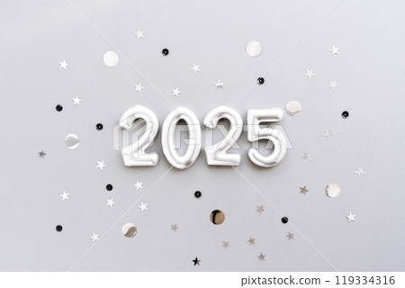 Greeting card - happy new year with numbers 2025 and silver glitter on grey textured background 119334316