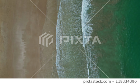 Sea waves breaking on sand beach Sea waves breaking on sand beach 119334390