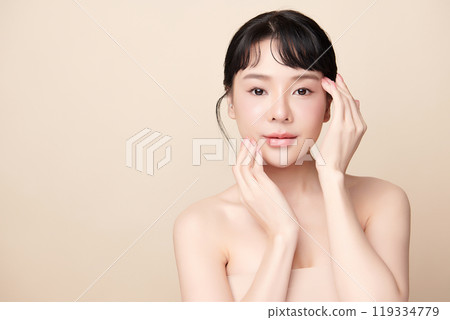 Beautiful young asian woman with clean fresh skin on beige background, Face care, Facial treatment, Cosmetology, beauty and spa, Asian women portrait. 119334779