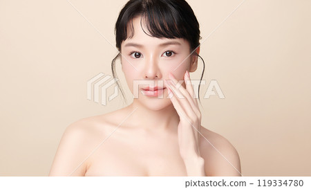Beautiful young asian woman with clean fresh skin on beige background, Face care, Facial treatment, Cosmetology, beauty and spa, Asian women portrait. Beautiful young asian woman with clean fresh skin on beige background, Face care, Facial treatment, Cosmetology, beauty and spa, Asian women portrait. 119334780