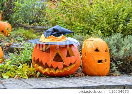 Halloween pumpkins. Decorated pumpkins ready for Halloween. Outdoor decorations for Halloween Halloween pumpkins. Decorated pumpkins ready for Halloween. Outdoor decorations for Halloween 119334973