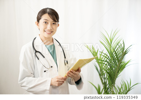 Female doctor smiling with medical record 119335349