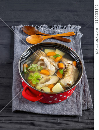 Clear Pike soup with veggies and spices, top view 119335542
