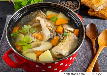 Clear Pike soup with veggies and spices, top view 119335543