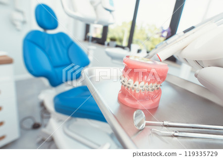 Dental office with a model of a tooth on a tray 119335729
