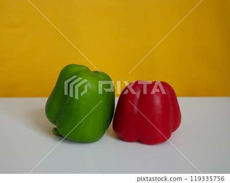 Green and red Bell Peppers sweet paprika at yellow background 119335756
