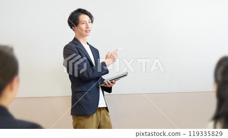 A man giving a lecture in front of a whiteboard A man giving a lecture in front of a whiteboard 119335829