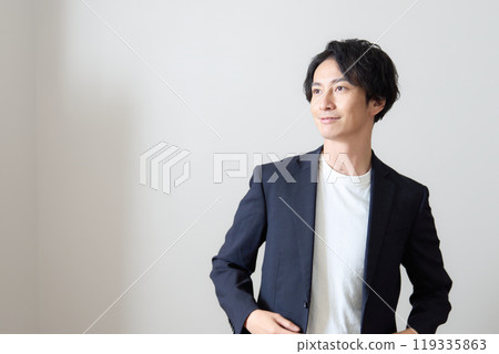 Smiling young man looking into the distance, business casual Smiling young man looking into the distance, business casual 119335863