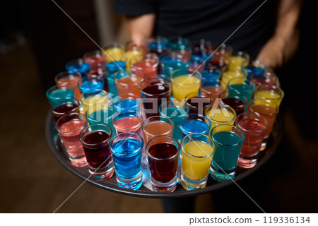 Vibrant and Colorful Shot Glasses Arranged on a Tray for a Fun and Lively Party Event 119336134