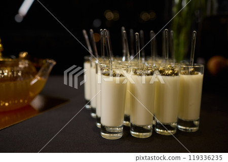 Beautifully Elegant Shots of Creamy and Luxurious Dessert Presented with Gold Decor 119336235