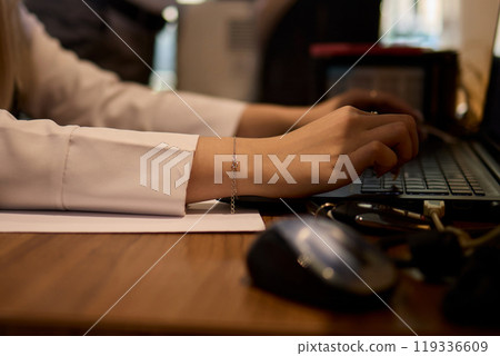 A Close Up View of a Hand Actively Using a Computer Mouse in a Professional Office Setting 119336609