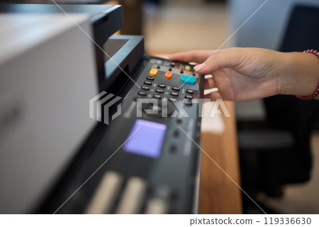 A Detailed Close Up of a Media Control Device Being Actively Used in a Creative Workspace A Detailed Close Up of a Media Control Device Being Actively Used in a Creative Workspace 119336630