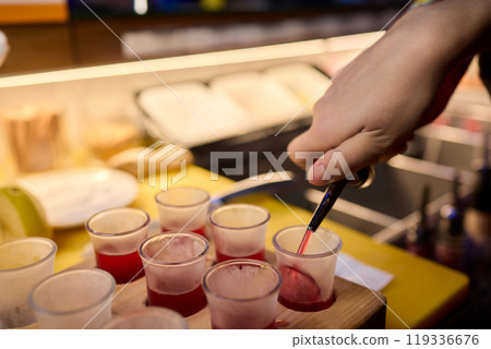 Vibrant and Colorful Shot Glasses Arranged on a Tray for a Fun and Lively Party Event Vibrant and Colorful Shot Glasses Arranged on a Tray for a Fun and Lively Party Event 119336676