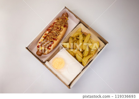 Gourmet Hot Dog featuring Crispy Toppings along with a delicious Sauce for extra flavor Gourmet Hot Dog featuring Crispy Toppings along with a delicious Sauce for extra flavor 119336693