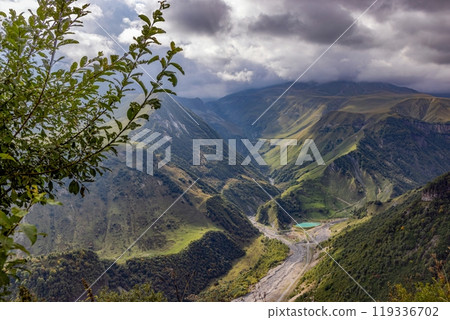 Scenic view of the Cross Pass in Georgia, showcasing lush green mountains and a winding valley 119336702