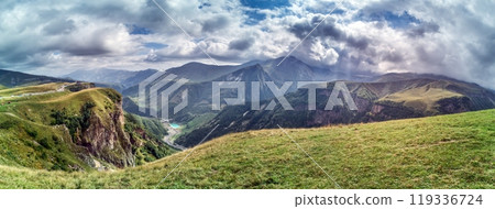 Scenic view of the Cross Pass in Georgia, showcasing lush green mountains and a winding valley 119336724