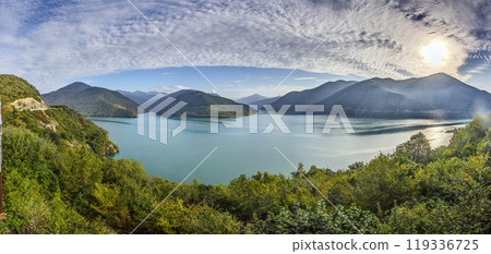 Drone view of the Zhinvali Reservoir in Georgia, surrounded by lush green mountains and blue waters 119336725