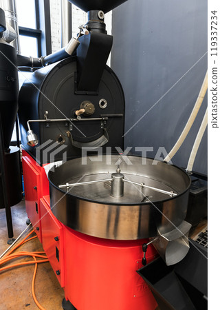 Coffee roaster stands in a coffeehouse, vertical photo Coffee roaster stands in a coffeehouse, vertical photo 119337234