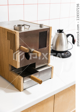 Professional sample roaster for coffee beans is on white desk 119337236