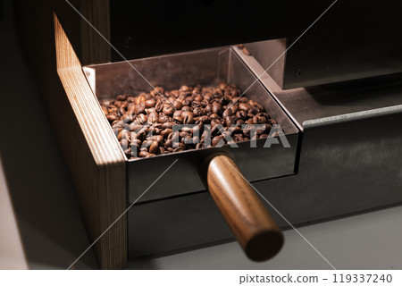 A portion of roasted arabica coffee beans just after roasting, close-up A portion of roasted arabica coffee beans just after roasting, close-up 119337240