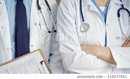 Professional healthcare team in uniform. Two doctors with stethoscopes are standing straight with arms crossed. Medicine concept Professional healthcare team in uniform. Two doctors with stethoscopes are standing straight with arms crossed. Medicine concept 119337841
