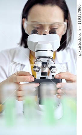 Woman scientist using microscope in laboratory. Microbiology science concept Woman scientist using microscope in laboratory. Microbiology science concept 119337966