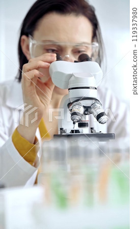Woman scientist using microscope in laboratory. Microbiology science concept 119337980