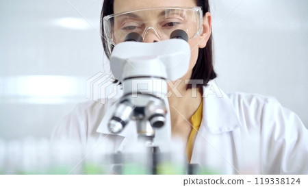 Woman scientist using microscope in laboratory. Microbiology science concept Woman scientist using microscope in laboratory. Microbiology science concept 119338124