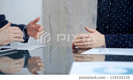 Professional handshake between two professionals and applauds at a corporate meeting with reflection on table over a business meeting. Business people concept 119338150