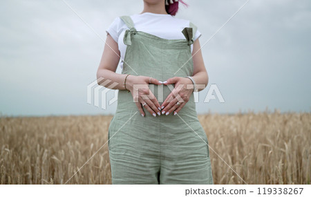 Pregnant Rustic Woman Holding Heart-Shaped Form On Belly, Natural Background.mom Pregnant Rustic Woman Holding Heart-Shaped Form On Belly, Natural Background.mom 119338267