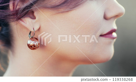 Young Woman With Jewellery Earrings Posing Outdoors. Jewelry Details,Marble Ball Young Woman With Jewellery Earrings Posing Outdoors. Jewelry Details,Marble Ball 119338268