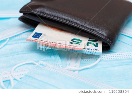 Black Men's Wallet with Euro Money Inside on the Blue Disposable Medical Face Masks Black Men's Wallet with Euro Money Inside on the Blue Disposable Medical Face Masks 119338804