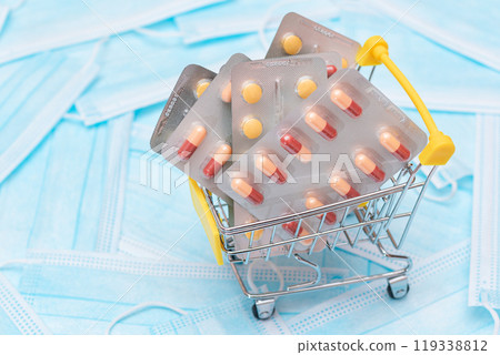Pills and Capsules in Shopping Cart on the Surgical Masks Pills and Capsules in Shopping Cart on the Surgical Masks 119338812